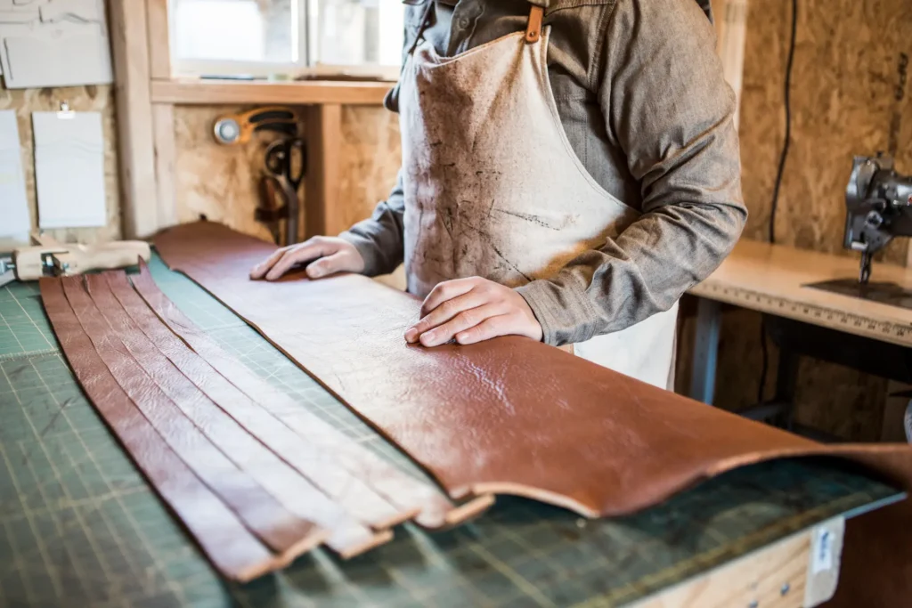 leather craftsman with strips of leather on worksh 2024 11 03 02 36 21 utc